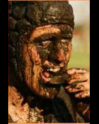 rugby players face caked in mud