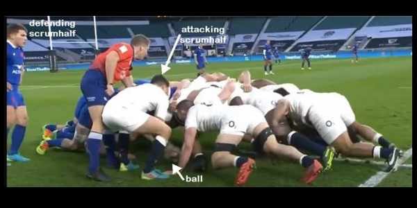 scrumhalf feeding ball into scrum